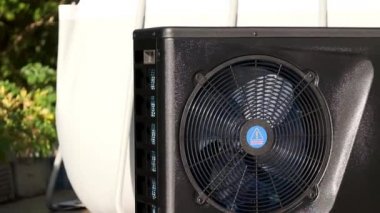 Heat pump.Pool heating.Device for heating water and air. Alternative energy.Black heat pump with spinning fan. 4k footage