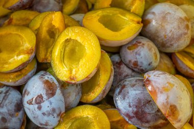 Plum halves background. Juicy pulp of plums texture.organic bio fruits.Plums harvest.Plum jam preparation.plum abundance 