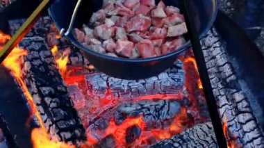 Meat on the fire.Cooking meat in a cauldron. High quality 4k footage