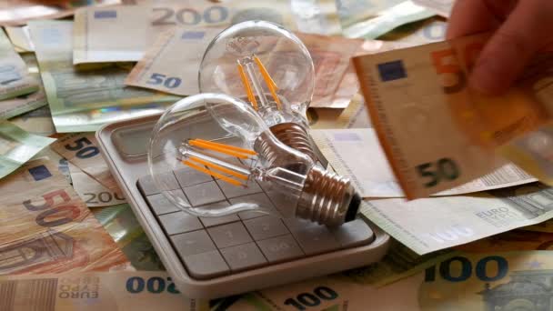 Electricity Bill Payment Hands Counting Money Und Light Bulbs Calculator — стоковое видео