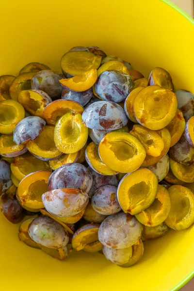 Plum halves .Yellow pulp of fruits in a yellow cup. Juicy pulp texture.Farm organic bio fruits.Plums harvest