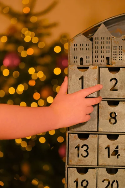 advent calendar.hand opens the advent calendar. traditions and symbols.Gifts and surprises for Christmas and New Year