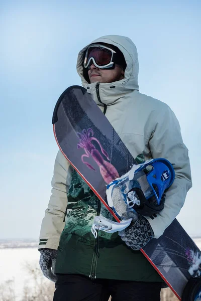 Zbliżenie Pionowy Portret Młodego Człowieka Trzymającego Snowboard Tle Błękitnego Nieba — Zdjęcie stockowe