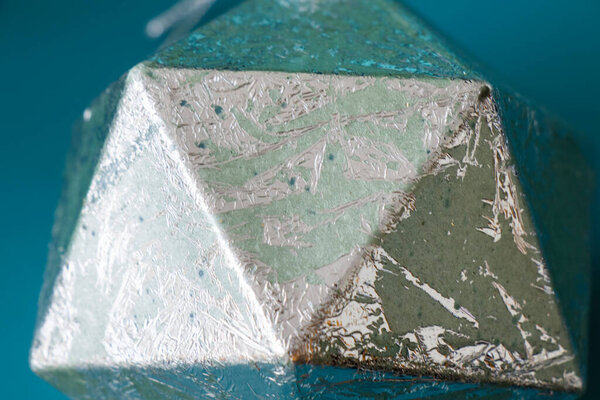 geometric figure icosahedron on the blue background, painted icosahedron