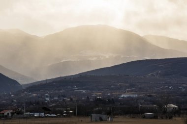Mountain and town landscape during sunset in Kaspi, Georgia