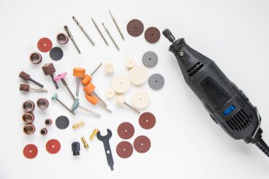 Dremel rotary kit, dremel heads, instrument for handwork on white background