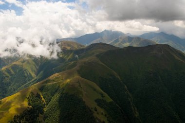 Tusheti mountain landscape and view, high angle, Georgian nature, clouds and forest