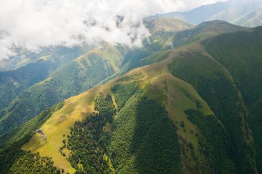 Tusheti mountain landscape and view, high angle, Georgian nature, clouds and forest