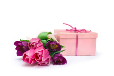 Bouquet of violet and pink tulips with pink gift box on a white background with space for text. Holiday spring composition