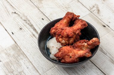 Kızarmış tavuk, buğulanmış pirinç, arka planda Asya sokak yemekleri.