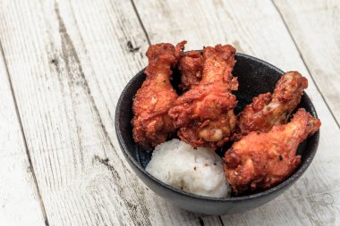 Kızarmış tavuk, buğulanmış pirinç, arka planda Asya sokak yemekleri.