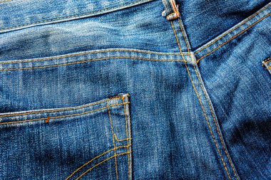 Kot pantolon, mavi kot kumaş dokusu, klasik kot pantolon dokusu, yakın çekim. Reklam veya klasik arkaplan için kopyalama alanı olan kot dokusunun mavi rengi.