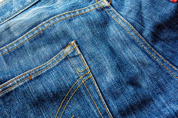 Kot pantolon, mavi kot kumaş dokusu, klasik kot pantolon dokusu, yakın çekim. Reklam veya klasik arkaplan için kopyalama alanı olan kot dokusunun mavi rengi.