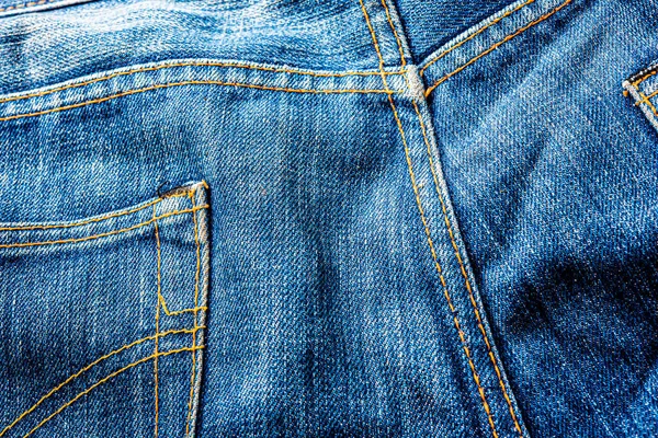 Kot pantolon, mavi kot kumaş dokusu, klasik kot pantolon dokusu, yakın çekim. Reklam veya klasik arkaplan için kopyalama alanı olan kot dokusunun mavi rengi.