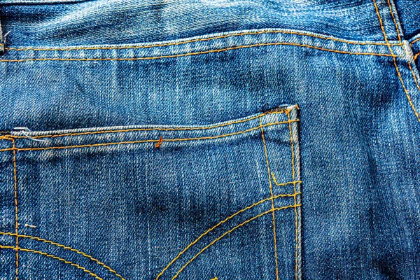 Kot pantolon, mavi kot kumaş dokusu, klasik kot pantolon dokusu, yakın çekim. Reklam veya klasik arkaplan için kopyalama alanı olan kot dokusunun mavi rengi.