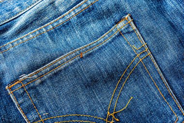 Kot pantolon, mavi kot kumaş dokusu, klasik kot pantolon dokusu, yakın çekim. Reklam veya klasik arkaplan için kopyalama alanı olan kot dokusunun mavi rengi.