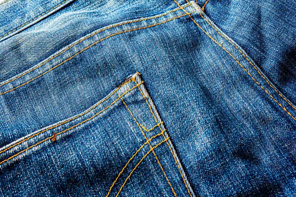 Kot pantolon, mavi kot kumaş dokusu, klasik kot pantolon dokusu, yakın çekim. Reklam veya klasik arkaplan için kopyalama alanı olan kot dokusunun mavi rengi.