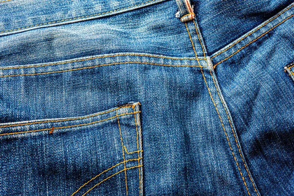 Kot pantolon, mavi kot kumaş dokusu, klasik kot pantolon dokusu, yakın çekim. Reklam veya klasik arkaplan için kopyalama alanı olan kot dokusunun mavi rengi.