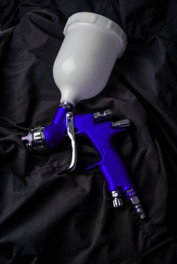Paint spray on wooden floors Image of the painter's arm hand holding industrial size spray gun used for industrial painting and coating and isolated on background clipingpart