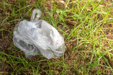 Plastic bags waste on the grass. Garbage dumped on the grass. technology for recycling