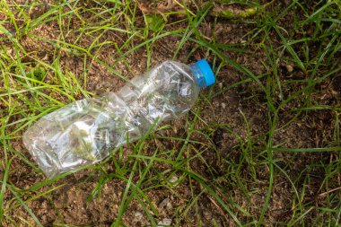 Plastic bags waste on the grass. Garbage dumped on the grass. technology for recycling
