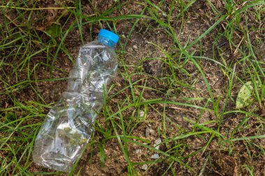 Plastic bags waste on the grass. Garbage dumped on the grass. technology for recycling