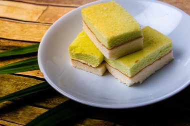 Pandan cake on the wooden floor sweet, soft, delicious food background with high resolution