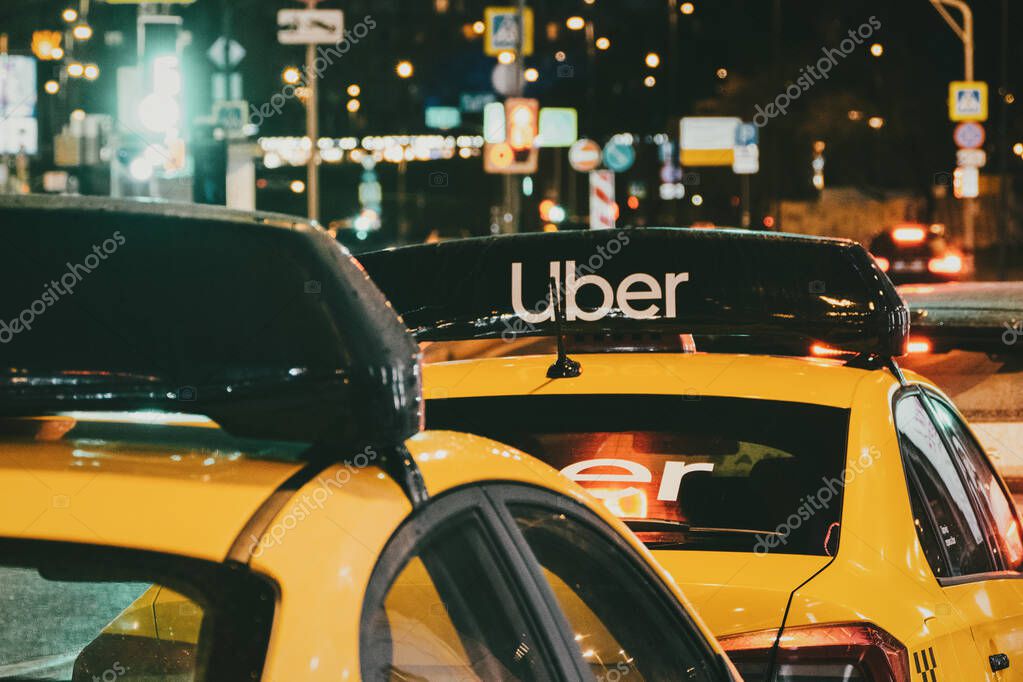 Taxi stand with Uber yellow cabs at night, Moscow, 31 Oct 2021