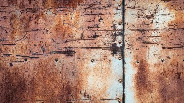 Rusty metal background, scratches stains rivets and seams on textured iron wall