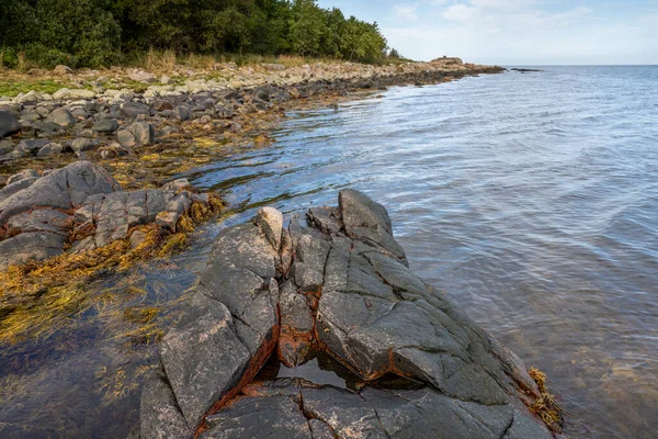 Ein Fels gegen blaues Wasser. Bild aus Skalderviken, Schweden — Stockfoto