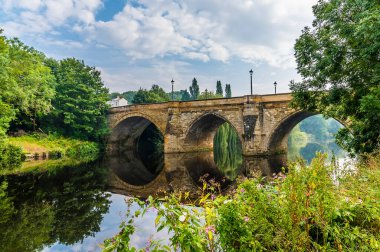 A view looking back towards the Yarm Road Bridge over the River Tees at Yarm, Yorkshire, UK in summertime clipart