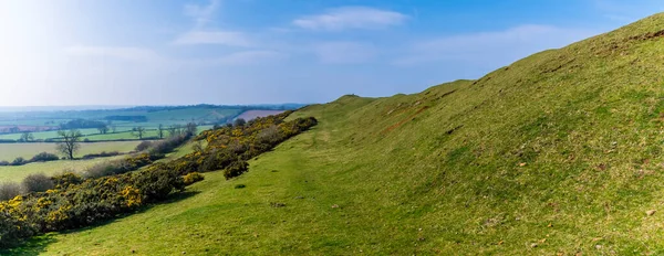 A view along the southern ramparts of the Iron Age Hill fort remains at Burrough Hill in Leicestershire, UK in early spring