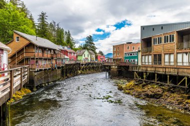 A view past stilted buildings down the Creek in Ketchikan, Alaska in summertime