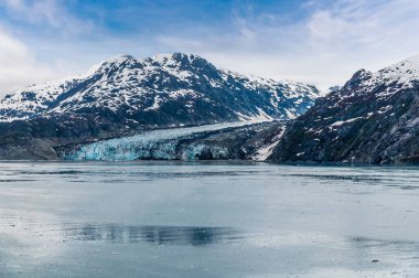 A view along the rocky sides of Glacier Bay towards the Reid Glacier, Alaska in summertime
