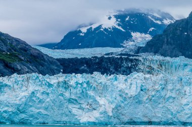 A view of the jagged ice wall of the Marjerie Glacier in Glacier Bay, Alaska in summertime