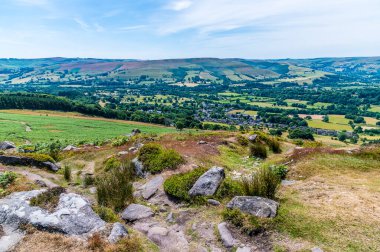 A view down from the Bamford Edge escarpment towards Bamford town in summertime