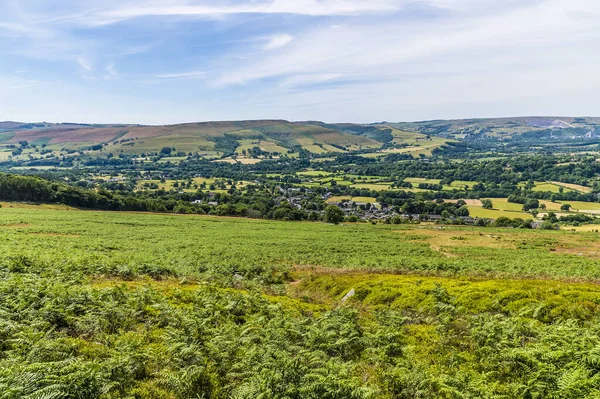 A view from the lower reaches of Bamford Edge towards Bamford town in summertime