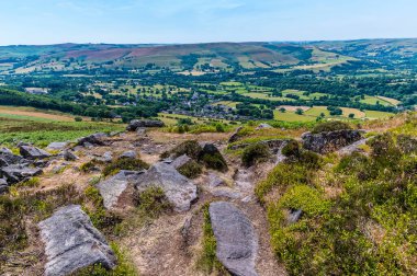 A view of Bamford and rock outcrops on the top of the Bamford Edge escarpment in summertime