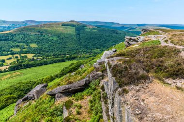 A view north along the rocky cliff edge on the top of Bamford Edge, UK in summertime