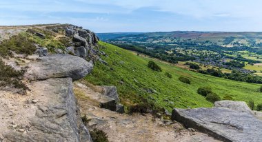 A view along the rocky cliff edge on the top of Bamford Edge, UK in summertime