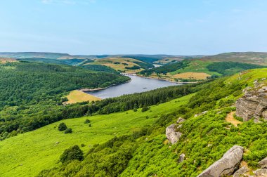 A view down the slopes on Bamford Edge towards Ladybower reservoir, UK in summertime