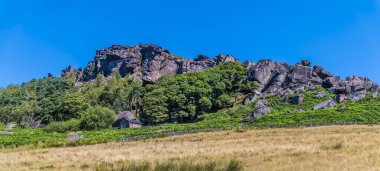 A view looking up from the base of the Roaches escarpment, Staffordshire, UK in summertime