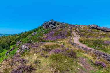 A view of a meandering path leading up to a summit of the Roaches escarpment, Staffordshire, UK in summertime