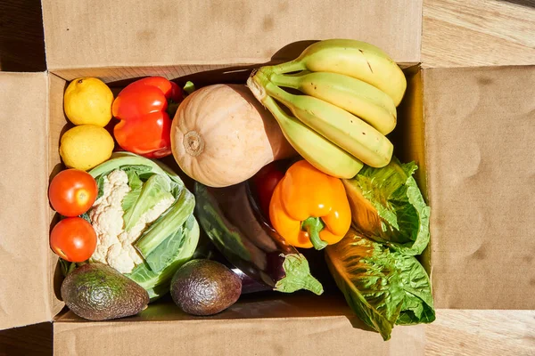 vegetables and fruits in a delivery box. fast delivery of fresh products. food for vegetarian and vegan