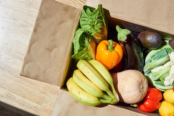 vegetables and fruits in a delivery box. fast delivery of fresh products. food for vegetarian and vegan