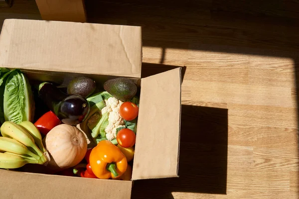 vegetables and fruits in a delivery box. fast delivery of fresh products. food for vegetarian and vegan