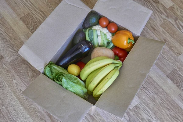 vegetables and fruits in a delivery box. fast delivery of fresh products. food for vegetarian and vegan