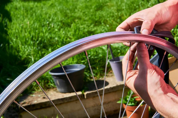 bicycle repair. repairing a flat tire of an bicycle tire, change the inner tube of an bicycle tire in backyard after a puncture