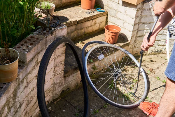 bicycle repair. repairing a flat tire of an bicycle tire, change the inner tube of an bicycle tire in backyard after a puncture