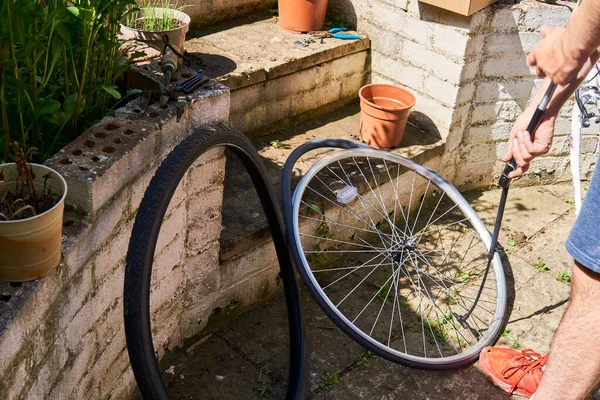 bicycle repair. repairing a flat tire of an bicycle tire, change the inner tube of an bicycle tire in backyard after a puncture